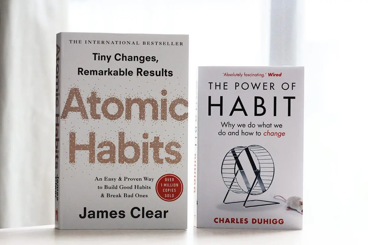 atomic habits vs the power of habit book covers